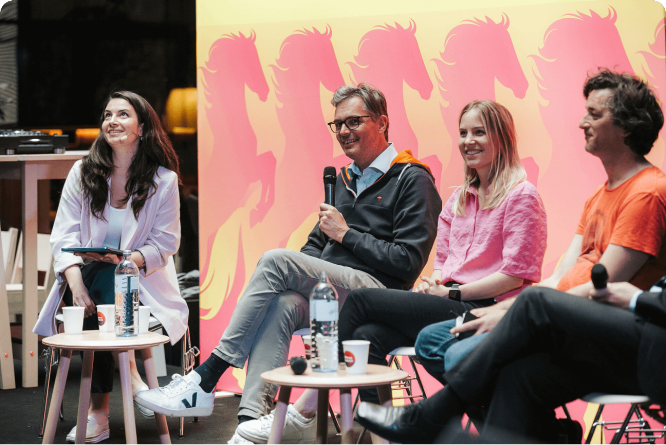 Panelists engaging in a casual discussion at a creative event, focusing on innovation, collaboration, and industry insights.